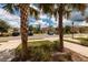 Community entrance with lush landscaping and parking at 17860 Althea Blue Pl, Lutz, FL 33558