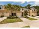 Tan townhouses with garages and landscaping at 17860 Althea Blue Pl, Lutz, FL 33558