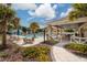 Relaxing community pool with covered patio and seating at 17860 Althea Blue Pl, Lutz, FL 33558