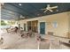 Community patio with tables, chairs, and ceiling fans at 17860 Althea Blue Pl, Lutz, FL 33558