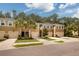 Three tan townhouses with garages and palm trees at 17860 Althea Blue Pl, Lutz, FL 33558