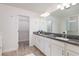 Double vanity bathroom with granite countertop at 17860 Althea Blue Pl, Lutz, FL 33558