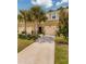 Tan townhouses with attached garages and palm trees at 17860 Althea Blue Pl, Lutz, FL 33558