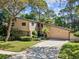 Charming two-story home with landscaped yard and a long driveway leading to the attached two-car garage at 3047 Enisglen Dr, Palm Harbor, FL 34683