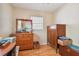 Second bedroom with wooden armoire and dresser at 6220 5Th S Ave, St Petersburg, FL 33707