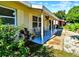 Inviting covered porch with seating, perfect for enjoying the outdoors and beautiful landscaping at 6220 5Th S Ave, St Petersburg, FL 33707