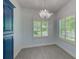 Dining area featuring a decorative chandelier and large windows with plantation shutters at 9883 Sago Point Dr, Seminole, FL 33777