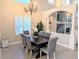 Charming dining room with a chandelier, bright window and neutral colors for elegant meals and gatherings at 9883 Sago Point Dr, Seminole, FL 33777