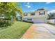 Two-story house with a driveway and lush green lawn at 13532 Alpine Ave, Seminole, FL 33776