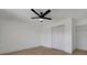 Simple bedroom with light wood floors, ceiling fan and closet at 5695 67Th N Ave # 122, Pinellas Park, FL 33781