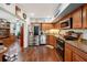 Kitchen with stainless steel appliances, wood cabinets, and granite countertops at 2430 Brazilia Dr # 24, Clearwater, FL 33763