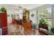 Spacious sunroom with hardwood floors, built-in shelving and large windows at 2430 Brazilia Dr # 24, Clearwater, FL 33763