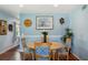 Bright dining room with wood table and four chairs, featuring wood floors and decorative wall art at 2430 Brazilia Dr # 24, Clearwater, FL 33763