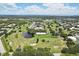 Aerial view of community, highlighting the golf course and pond at 2430 Brazilia Dr # 24, Clearwater, FL 33763