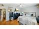 Bedroom with king-size bed, dresser, mini-fridge, and access to another room at 2430 Brazilia Dr # 24, Clearwater, FL 33763