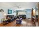 Living room with comfortable seating, wood floors and large TV at 2430 Brazilia Dr # 24, Clearwater, FL 33763