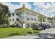 Two-story building with parking and surrounding greenery at 2430 Brazilia Dr # 24, Clearwater, FL 33763