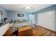 Primary bedroom with king bed, brown leather bench, and white dresser at 2430 Brazilia Dr # 24, Clearwater, FL 33763