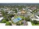 Aerial view showing community pool, tennis courts, and buildings at 2430 Brazilia Dr # 24, Clearwater, FL 33763