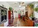 Sunroom with hardwood floors, built-in shelving and a dog pen at 2430 Brazilia Dr # 24, Clearwater, FL 33763