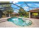 Enjoy this refreshing pool and spa with a screened enclosure at 4508 Grand Lakeside Dr, Palm Harbor, FL 34684