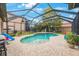 Inviting screened pool area with a freeform pool and spacious deck at 4508 Grand Lakeside Dr, Palm Harbor, FL 34684