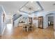 Bright dining room with a farmhouse table and access to the kitchen at 4508 Grand Lakeside Dr, Palm Harbor, FL 34684