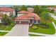 Two-story house with three-car garage, and a large backyard at 4508 Grand Lakeside Dr, Palm Harbor, FL 34684