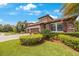 Beautiful two-story home with stone accents, three-car garage, and lush landscaping at 4508 Grand Lakeside Dr, Palm Harbor, FL 34684