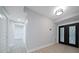 Bright entryway with double doors and modern light fixture at 50 Coe Rd # 125, Belleair, FL 33756