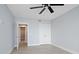 Bright bedroom with ceiling fan and access to hallway at 50 Coe Rd # 125, Belleair, FL 33756