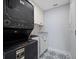 Stackable washer and dryer in a well-lit laundry room with stylish tile at 50 Coe Rd # 125, Belleair, FL 33756