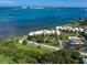 Aerial view of waterfront community with pool, lush landscaping, and bay access at 50 Coe Rd # 125, Belleair, FL 33756