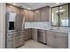 Modern kitchen with stainless steel appliances and gray cabinets at 50 Coe Rd # 125, Belleair, FL 33756
