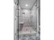 Large walk-in shower with glass enclosure, built-in seat, and modern fixtures at 50 Coe Rd # 125, Belleair, FL 33756