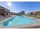 Inviting community pool with lounge chairs and umbrellas at 50 Coe Rd # 125, Belleair, FL 33756