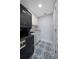 Stackable washer and dryer in a well-lit laundry room with stylish tile at 50 Coe Rd # 125, Belleair, FL 33756