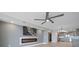 Living room with fireplace, ceiling fan and kitchen view at 50 Coe Rd # 125, Belleair, FL 33756
