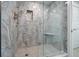 Large walk-in shower with marble tile and built-in seat at 50 Coe Rd # 125, Belleair, FL 33756