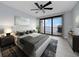 Bright bedroom with water views and sliding glass doors to balcony at 50 Coe Rd # 125, Belleair, FL 33756