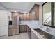 Modern kitchen with stainless steel appliances and gray cabinets at 50 Coe Rd # 125, Belleair, FL 33756