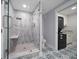 Large walk-in shower with glass enclosure, built-in seat, and modern fixtures at 50 Coe Rd # 125, Belleair, FL 33756