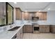 Modern kitchen with stainless steel appliances and gray cabinetry at 50 Coe Rd # 125, Belleair, FL 33756