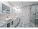 Modern bathroom with double vanity, updated fixtures, and patterned tile floor at 50 Coe Rd # 125, Belleair, FL 33756
