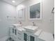 Modern bathroom with double vanity, updated fixtures, and patterned tile floor at 50 Coe Rd # 125, Belleair, FL 33756