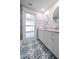 Updated bathroom with double vanity, marble counters, and patterned tile floor at 50 Coe Rd # 125, Belleair, FL 33756