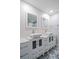 Modern bathroom with double sinks, updated vanity, and patterned floor tiles at 50 Coe Rd # 125, Belleair, FL 33756