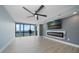 Living room with fireplace, ceiling fan, and water views at 50 Coe Rd # 125, Belleair, FL 33756