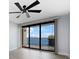 Bedroom with water view, sliding doors to balcony, and ceiling fan at 50 Coe Rd # 125, Belleair, FL 33756