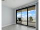 Bedroom with water view, sliding doors to balcony, and ceiling fan at 50 Coe Rd # 125, Belleair, FL 33756